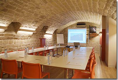 Photo 10 - Hotel Tilsitt Etoile Paris 3* star near the Champs Elysees and close to the Arch of Triumph - Our meeting room mixes perfectly the charm and character of an old restored cellar and its apparent blond stone  with the refreshing design and coloured furniture. 
Equiped with the Wi-Fi (wireless) network, it accomodates your business meetings  declined in Day meeting Pack, seminars semi-residential and residential or simple hiring at the day or half a day.
Capacity: 20/23 persons- Surface: 55 m2