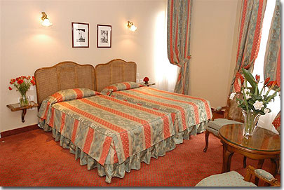 Photo 2 - Hotel de Sevigne Paris 3* star near the Champs Elysees and close to the Arch of Triumph - “Charm room” with twin beds private hall that protects the room from the noise of the corridor. 3 french windows, balcony, air-conditioning, WIFI system, safe, minibar, televisions with 20 channels, large working surface, bathroom with natural light and direct telephone line.